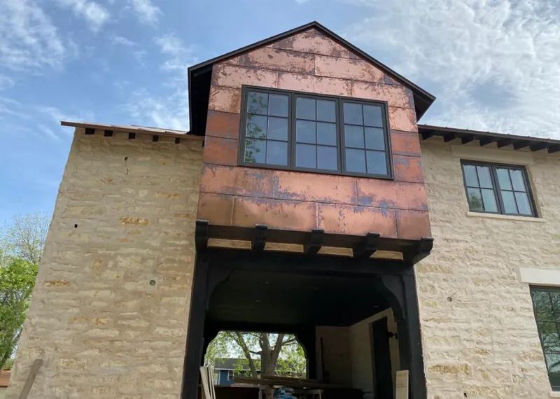 Copper metal panel facade on a stone building for Skylight Installation in Bayville